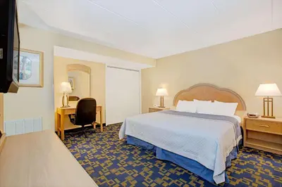 a hotel room with a bed and a desk at Windsor Hotel in East Windsor