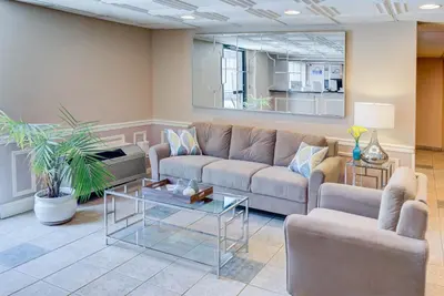 a living room with a couch and a table at Windsor Hotel in East Windsor