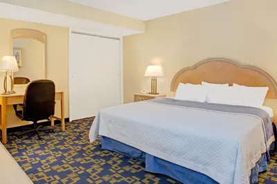 a hotel room with a bed and a desk at Windsor Hotel in East Windsor