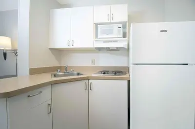 a kitchen with white cabinets and a white refrigerator at Extended Stay America Suites - Philadelphia - Bensalem in Bensalem