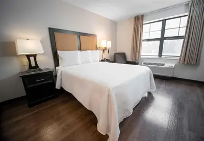 a bedroom with a large white bed and a window at Extended Stay America Suites - Philadelphia - Bensalem in Bensalem