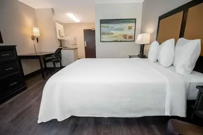 a hotel room with a large white bed and a desk at Extended Stay America Suites - Philadelphia - Bensalem in Bensalem