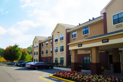 a row of buildings with cars parked in a parking lot at Extended Stay America Suites - Philadelphia - Bensalem in Bensalem