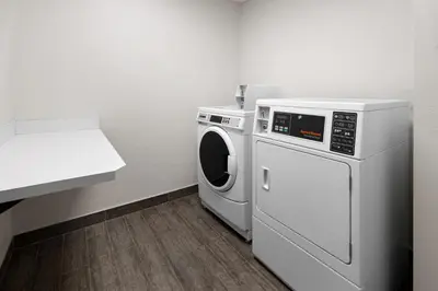 a white washer and dryer in a room at Holiday Inn Express & Suites Wyomissing by IHG in West Reading