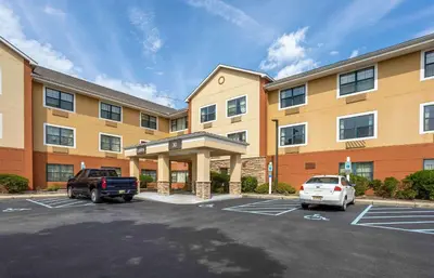 a large building with a car parked in a parking lot at Extended Stay America Suites - Somerset - Franklin in Somerset