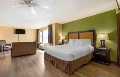 a bedroom with a large bed and a green wall at Extended Stay America Suites - Somerset - Franklin in Somerset