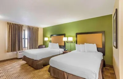 two beds in a hotel room with green walls at Extended Stay America Select Suites - Philadelphia - Malvern - Great Valley in Malvern