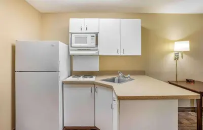 a kitchen with a white refrigerator and a microwave at Extended Stay America Select Suites - Philadelphia - Malvern - Great Valley in Malvern