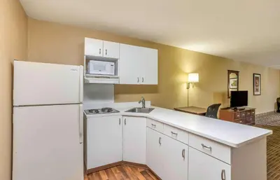 a kitchen with a white refrigerator and a microwave at Extended Stay America Select Suites - Philadelphia - Malvern - Great Valley in Malvern