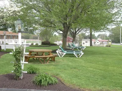 a picnic table and chairs in a park at Amish Country Motel in Bird in Hand
