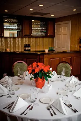 a table with plates and utensils in a restaurant at Lambertville House in Lambertville