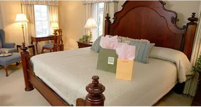 a bedroom with a large bed with a sign on it at Lambertville House in Lambertville