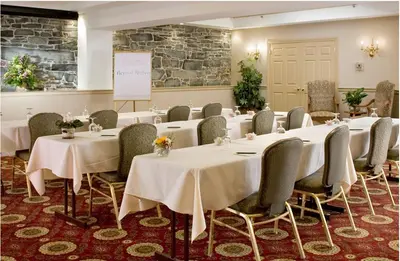 a conference room with white tables and chairs at Lambertville House in Lambertville