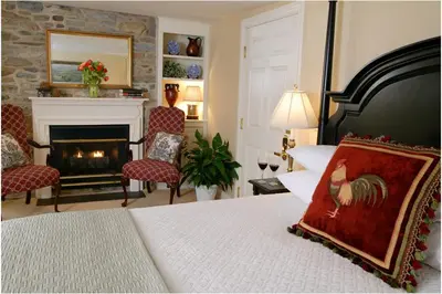 a bedroom with a bed with a fireplace at Lambertville House in Lambertville