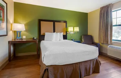 a hotel room with a large bed and a chair at Extended Stay America Suites - Mt Olive - Budd Lake in Budd Lake