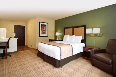 a hotel room with a bed and a desk and a chair at Extended Stay America Suites - Mt Olive - Budd Lake in Budd Lake