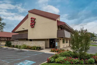 a restaurant with a sign on the side of a parking lot at Red Roof Inn Mt Laurel in Mount Laurel