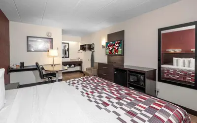 a hotel room with a bed and a desk at Red Roof Inn Mt Laurel in Mount Laurel
