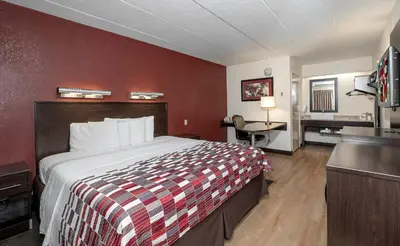 a hotel room with a bed and a desk at Red Roof Inn Mt Laurel in Mount Laurel