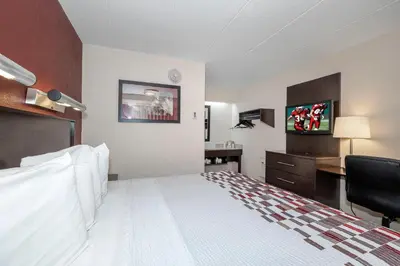 a hotel room with a bed and a desk at Red Roof Inn Mt Laurel in Mount Laurel