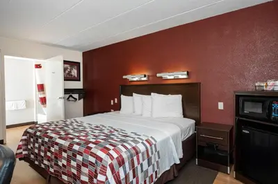 a hotel room with a bed and a tv at Red Roof Inn Mt Laurel in Mount Laurel