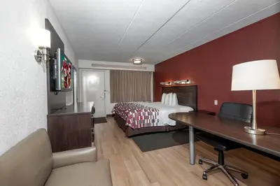 a hotel room with a bed and a desk at Red Roof Inn Mt Laurel in Mount Laurel