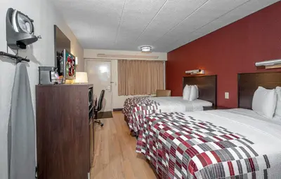 a hotel room with two beds and a flat screen tv at Red Roof Inn Mt Laurel in Mount Laurel