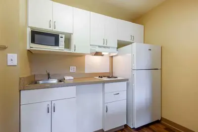 a kitchen with white cabinets and a white refrigerator at Extended Stay America Suites - Piscataway - Rutgers University in Randolphville