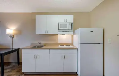 a kitchen with white cabinets and a white refrigerator at Extended Stay America Suites - Piscataway - Rutgers University in Randolphville