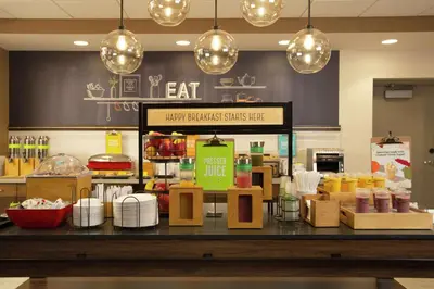 a restaurant with a counter with food on it at Hampton Inn & Suites Kutztown, Pa in Kutztown