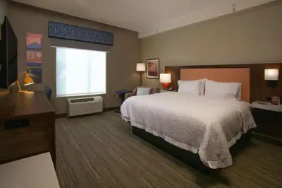 a hotel room with a large bed and a window at Hampton Inn & Suites Kutztown, Pa in Kutztown