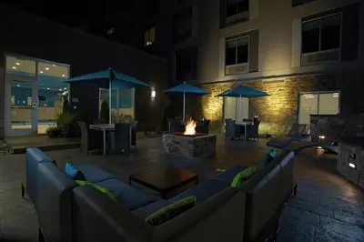 a patio with couches and a fire place at night at Hampton Inn & Suites Kutztown, Pa in Kutztown