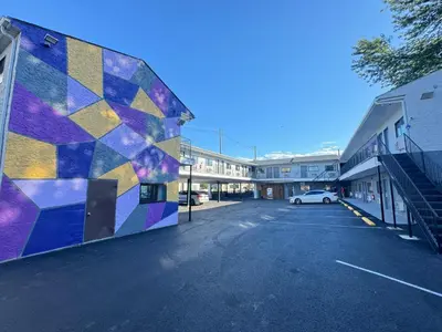a mural on the side of a building in a parking lot at Essence Express Elizabeth EWR Airport in Elizabeth