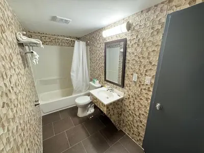 a bathroom with a sink and a toilet and a tub at Essence Express Elizabeth EWR Airport in Elizabeth