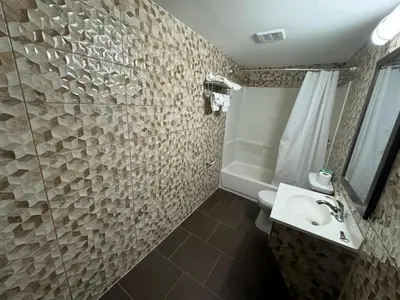 a bathroom with a toilet and a sink and a shower at Essence Express Elizabeth EWR Airport in Elizabeth