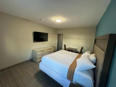 a hotel room with a bed and a television at Essence Express Elizabeth EWR Airport in Elizabeth