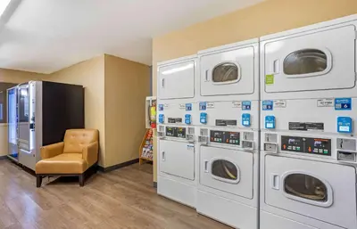 a room with four washing machines and a chair at Extended Stay America Suites - Philadelphia - Horsham - Welsh Rd in Horsham