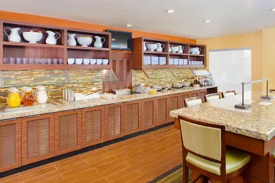 a large kitchen with wooden cabinets and a counter at Hyatt House Mount Laurel in Mount Laurel