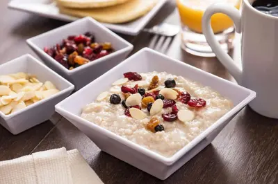 a bowl of oatmeal with fruit and nuts on a table at Hyatt House Mount Laurel in Mount Laurel