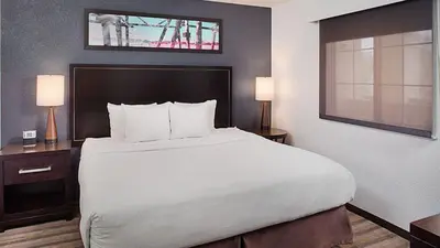 a large bed in a hotel room with two lamps at Hyatt House Mount Laurel in Mount Laurel