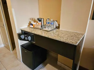 a kitchen with a counter with a coffee maker at Radisson Hotel Freehold in Freehold