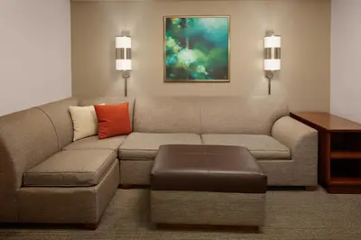 a living room with a couch and a table at Hyatt Place Princeton in Princeton