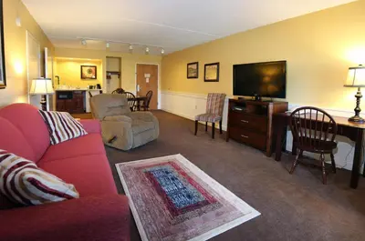 a living room with a red couch and a flat screen tv at Bird-in-Hand Family Inn in Bird in Hand