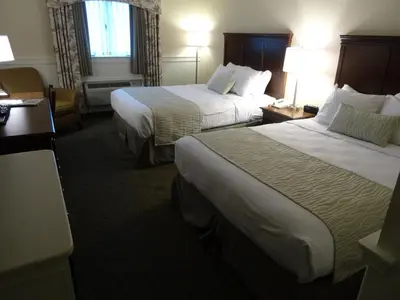 a hotel room with two beds and two lamps at Bird-in-Hand Family Inn in Bird in Hand