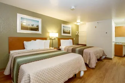a hotel room with two beds in a room at HomeTowne Studios by Red Roof Philadelphia - Maple Shade, NJ in Maple Shade