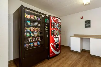 a cocacola soda vending machine in a room at HomeTowne Studios by Red Roof Philadelphia - Maple Shade, NJ in Maple Shade
