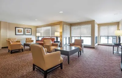 a waiting room with chairs and a couch and tables at Extended Stay America Suites - Philadelphia - Plymouth Meeting - East in Plymouth Meeting