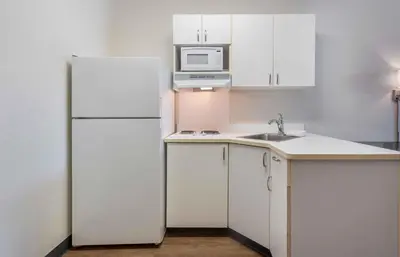 a white kitchen with a refrigerator and a sink at Extended Stay America Suites - Philadelphia - Plymouth Meeting - East in Plymouth Meeting