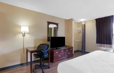 a hotel room with a bed and a desk with a television at Extended Stay America Suites - Philadelphia - Plymouth Meeting - East in Plymouth Meeting