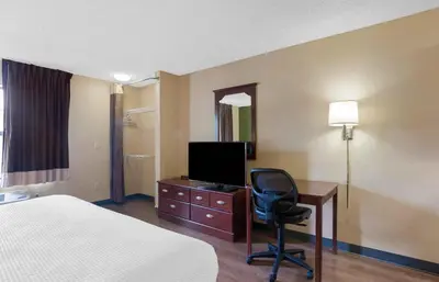 a hotel room with a bed and a desk with a television at Extended Stay America Suites - Philadelphia - Plymouth Meeting - East in Plymouth Meeting